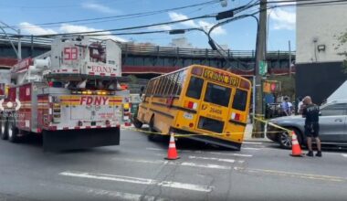 School bus in the Bronx partially trapped in a hole