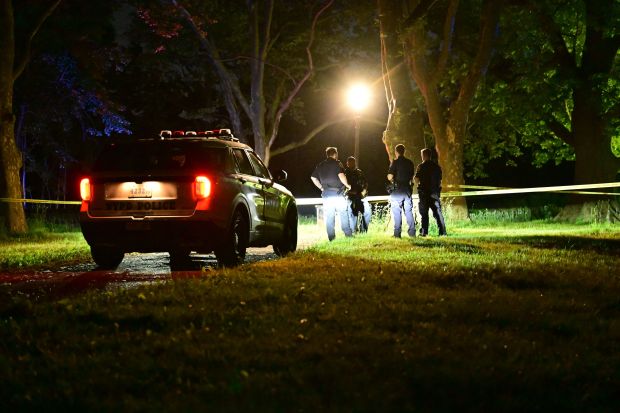 NYPD officers investigate following the discovery of the body of Albert Itzkowitz, who was found dead along the Kissena Lake shoreline with multiple gunshot wounds, in Queens, New York, on May 18, 2026. (Kyle Mazza/NurPhoto/Shutterstock)