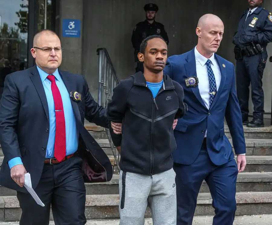 Detectives escort Zahir Davis, 18, out of the 113th Precinct stationhouse in Queens on April 25, 2026, following his arrest on murder charges in the fatal shooting of 15-year-old Jaden Pierre on April 16. 