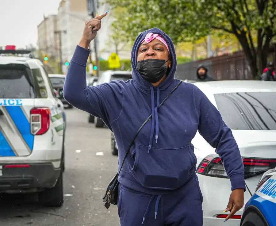 A woman who identified herself as Pierre’s cousin shouted profanities at Davis during his perp walk out of the 113th Precinct on April 24. 
