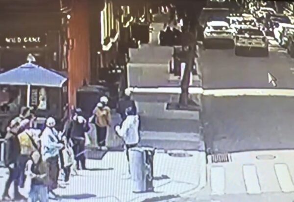 Police can be seen pushing the driver of the allegedly-stolen vehicle to the sidewalk on Orange Street. Photo: Private residence surveillance