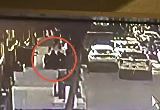Closeup showing police pushing driver of the allegedly-stolen vehicle to the sidewalk on Orange Street. Photo: Private residence surveillance
