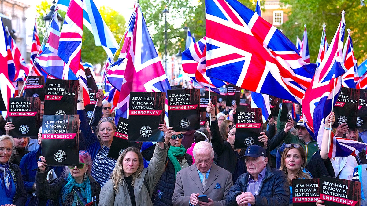 People attending a rally organized by the Campaign Against Antisemitism opposite Downing Street in London