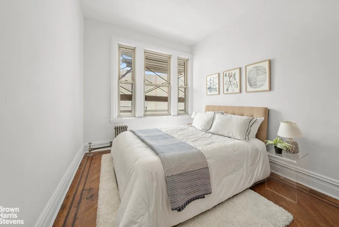 bedroom with wood floor, white walls