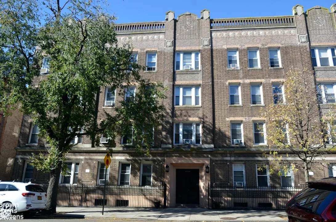 exterior of a brick four story apartment building