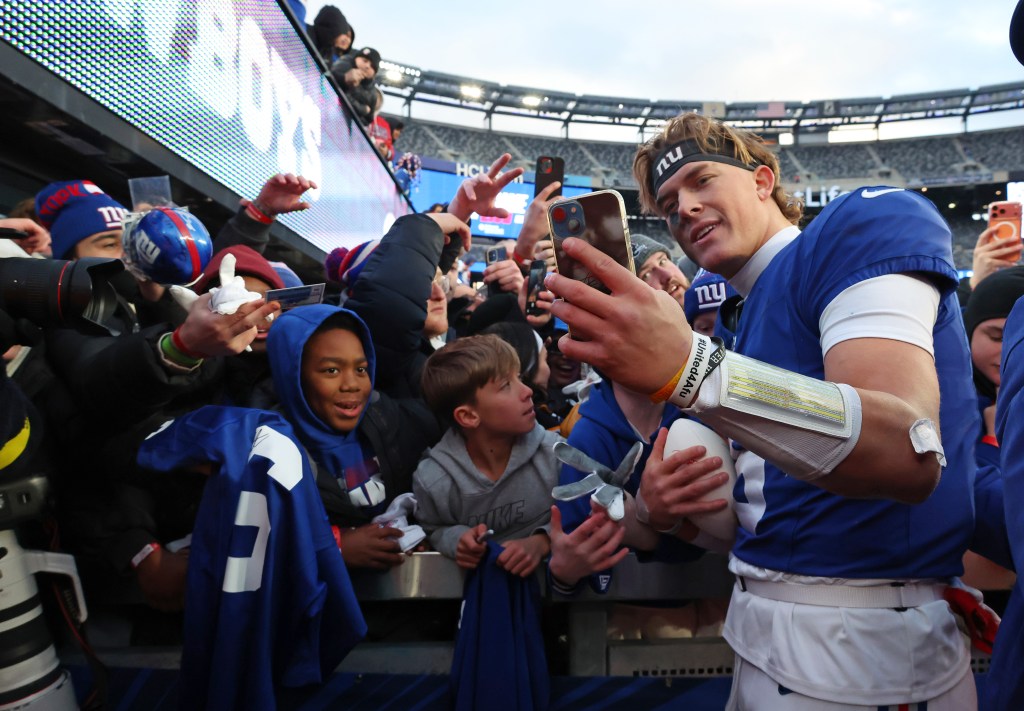 Jaxson Dart takes selfies fans after win over the Cowboys last season.