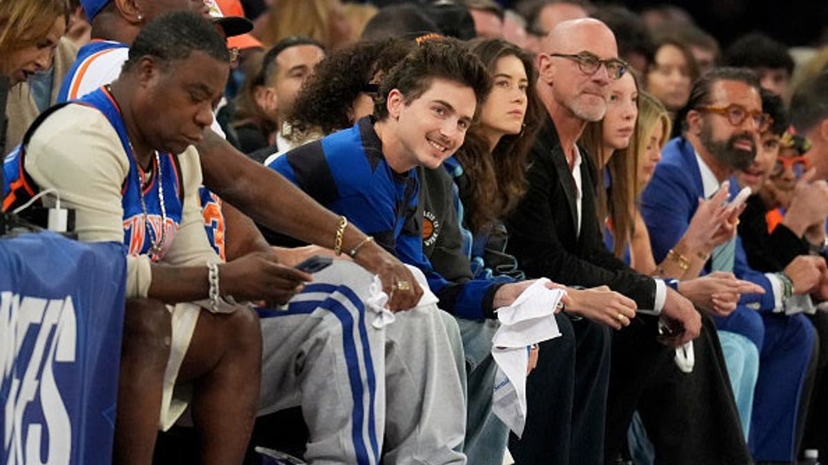 Timothee Chalamet seated at Madison Square Garden during a basketball game.
