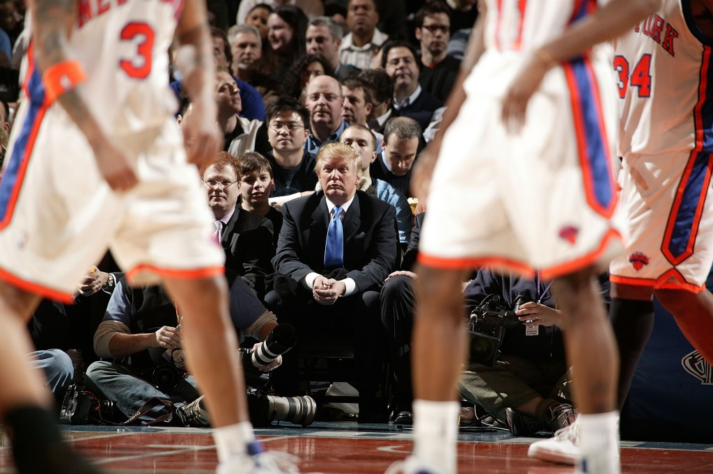 Donald Trump sitting courtside at a New York Knicks vs. Los Angeles Lakers basketball game.