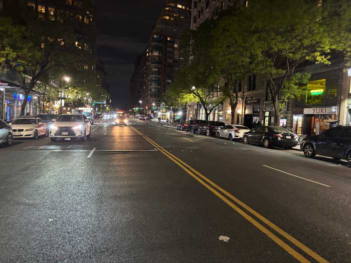 72nd street in Manhattan at night with few cars on it