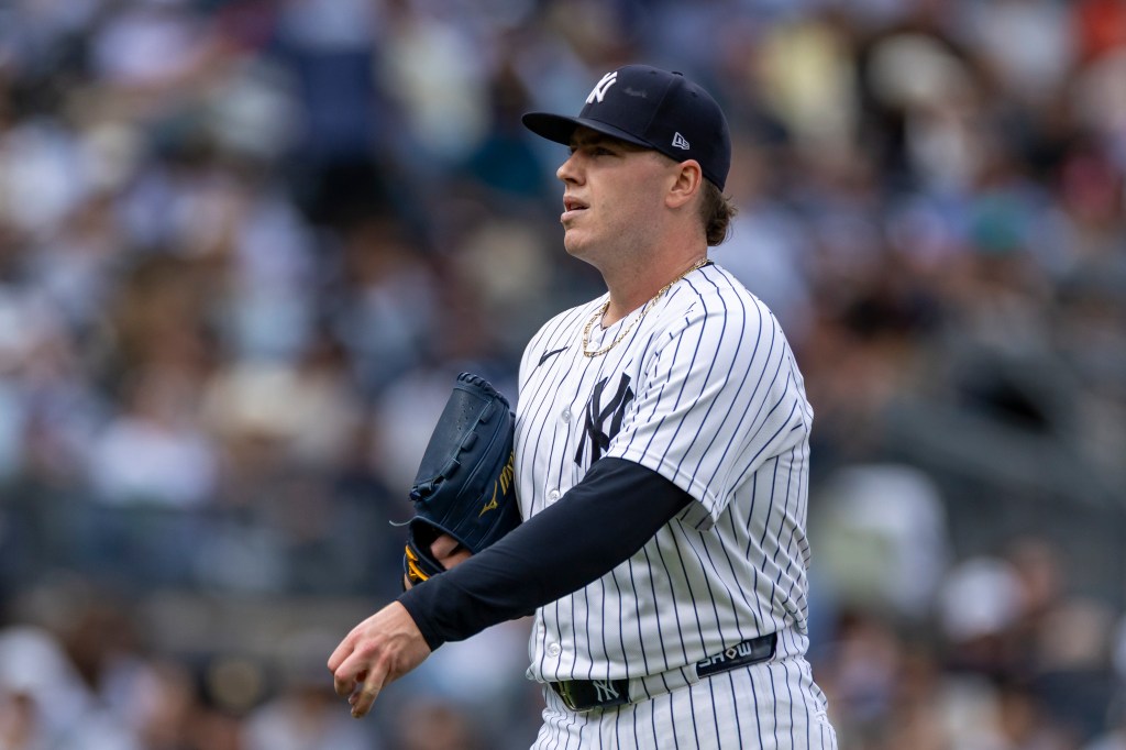 New York Yankees pitcher Ryan Weathers walks back to the dugout.