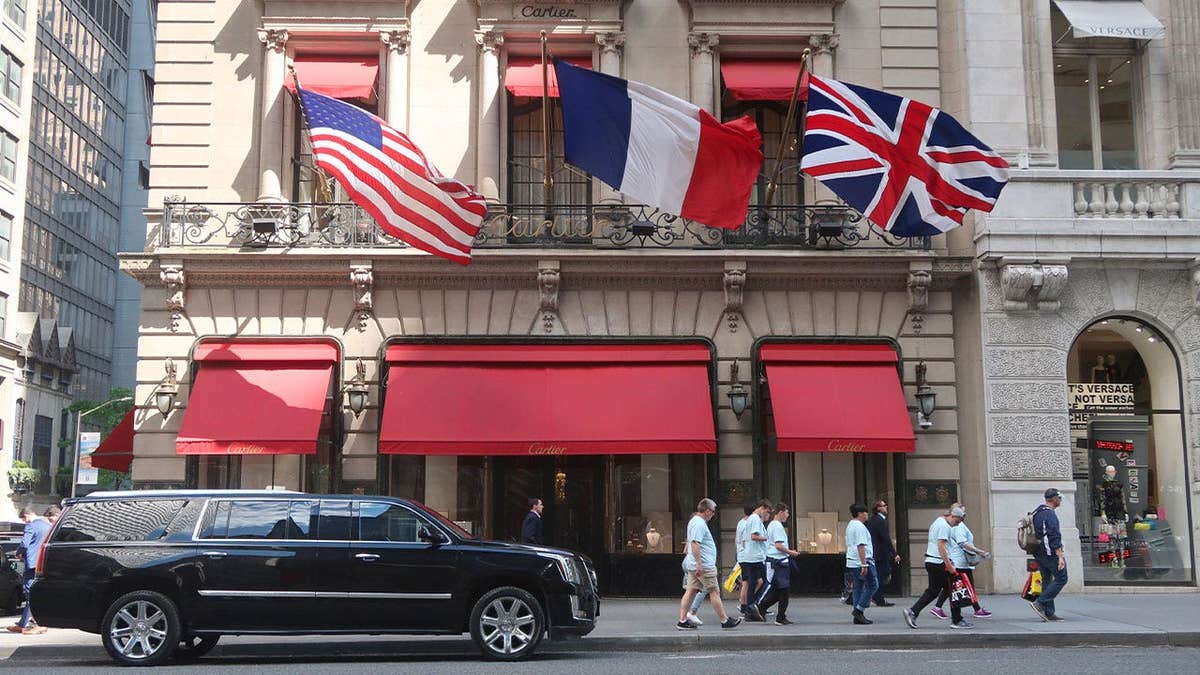 People walk past a Cartier store on 5th Avenue in New York City.