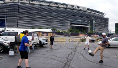 Fans play with a soccer ball outside the Metlife Stadium in East Rutherford, N.J., Sunday, July 13, 2025. (AP Photo/Pamela Smith, File)