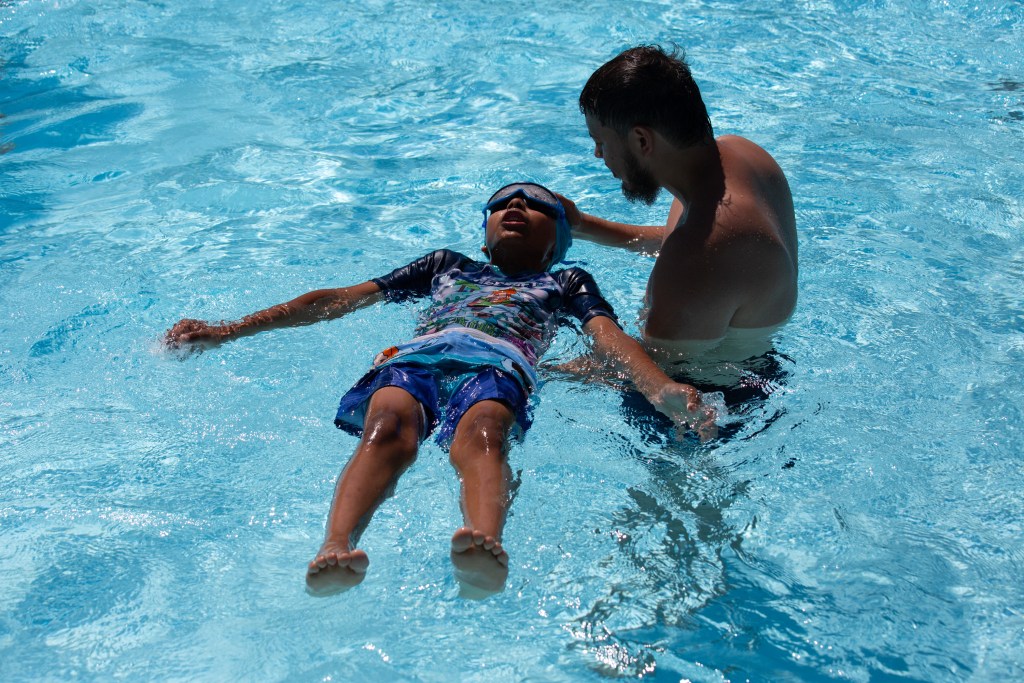 A swim instructor gives lessons at Astoria Pool during the first swim of the summer.