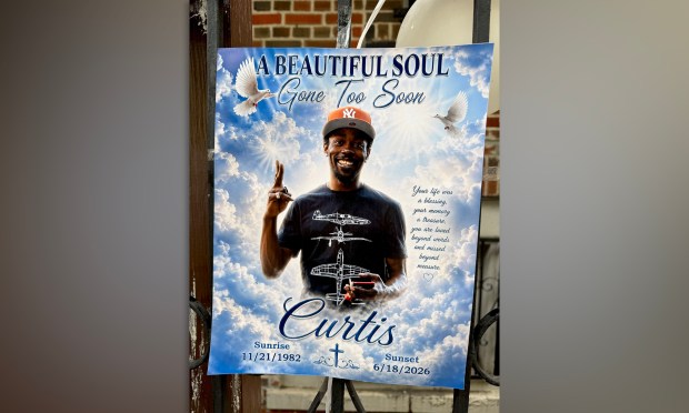 A memorial poster for victim Curtis Brown is seen near where he was killed.