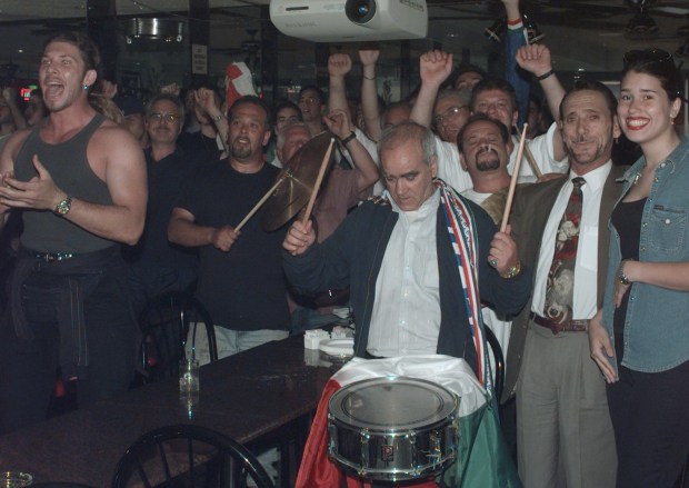 Fans watch the Italy vs. Chile match in the 1998 World Cup at a