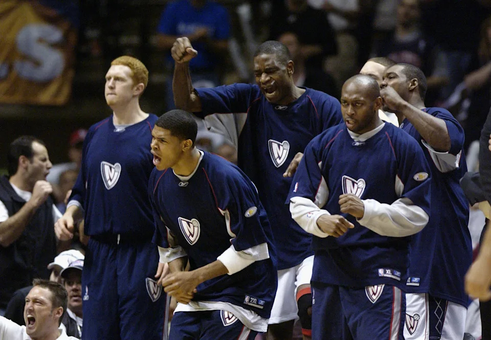 EAST RUTHERFORD, NJ - JUNE 8: (L-R) Brian Scalabrine #21, Tamar Slay #8, Dikembe Mutombo #55 and Anthony Johnson #2 of the New Jersey Nets cheer in Game three of the 2003 NBA Finals against the San Antonio Spursat Continental Airlines Arena on June 8, 2003 in East Rutherford, New Jersey. The Spurs won 84-79. NOTE TO USER: User expressly acknowledges and agrees that, by downloading and/or using this Photograph, User is consenting to the terms and conditions of the Getty Images License Agreement (Photo by Ezra Shaw/Getty Images)