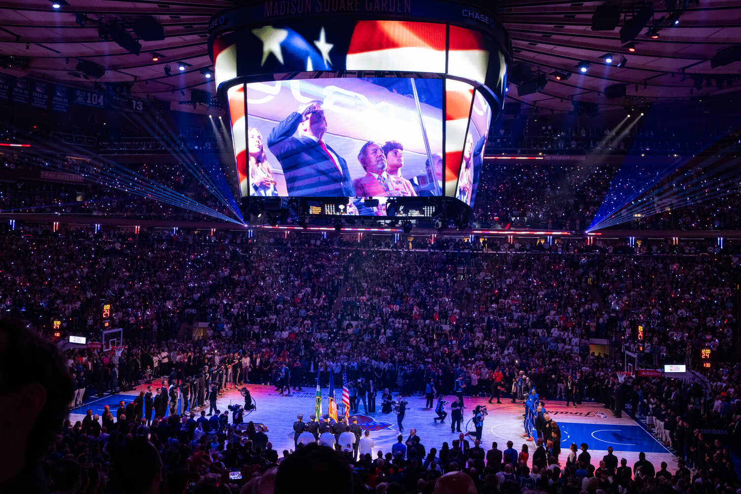 President Trump saluting as shown on a video board.