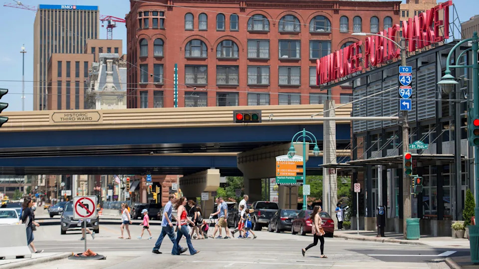 People walk in front of the Historic Third Ward's Public Market.
