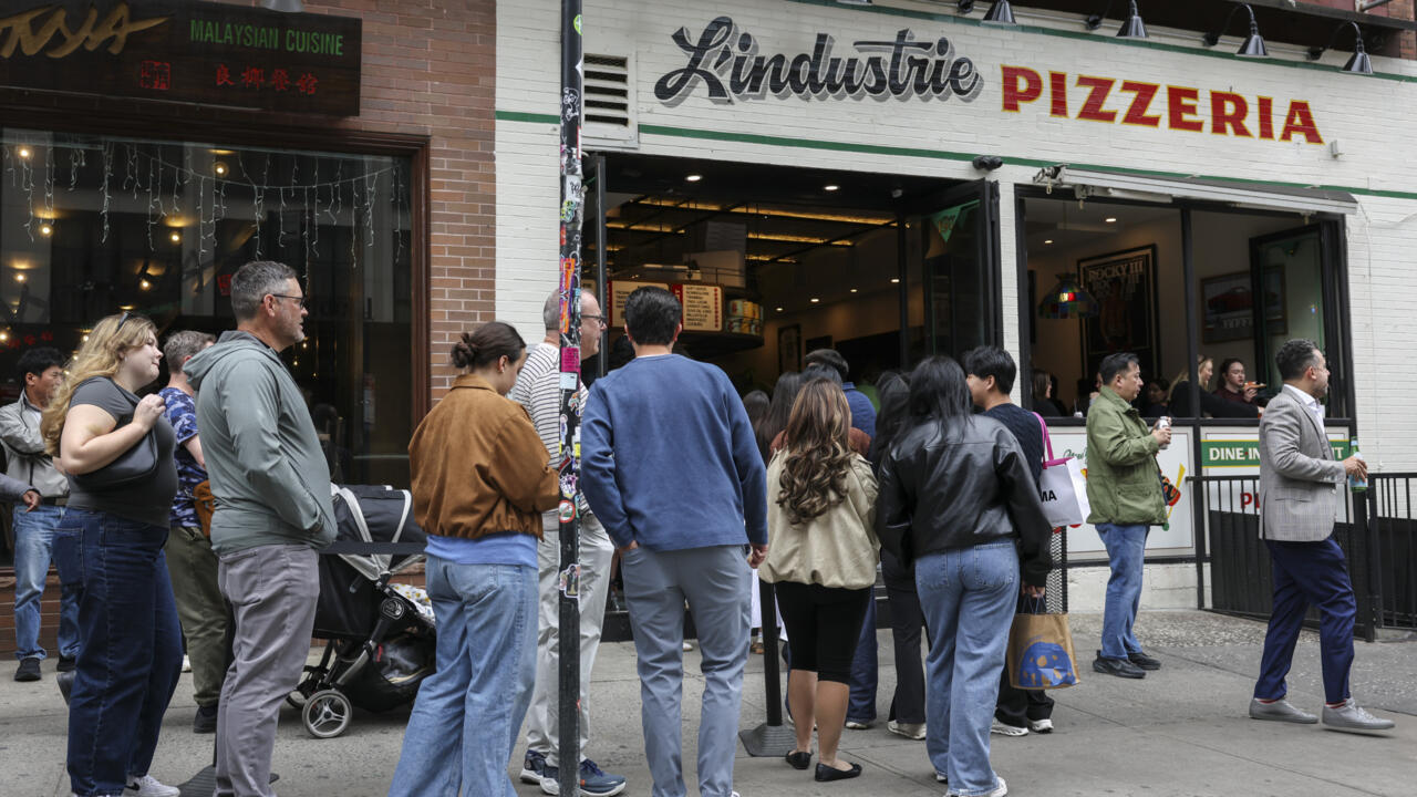 In New York, waiting in line becomes a social scene