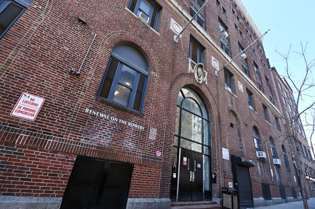 Exterior of the Bowery Mission's men's center, a brick building with "RENEWAL ON THE BOWERY" painted on the wall.