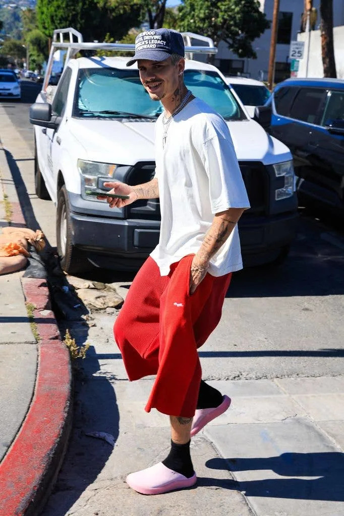 Romeo Beckham with a phone in his hand