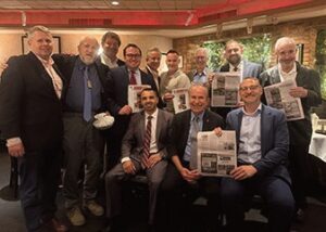 Several of the members proudly dis­playing the article in the Western Queens Gazette that the group ap­peared in the prior month.
