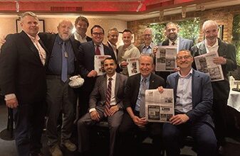 Several of the members proudly dis­playing the article in the Western Queens Gazette that the group ap­peared in the prior month.