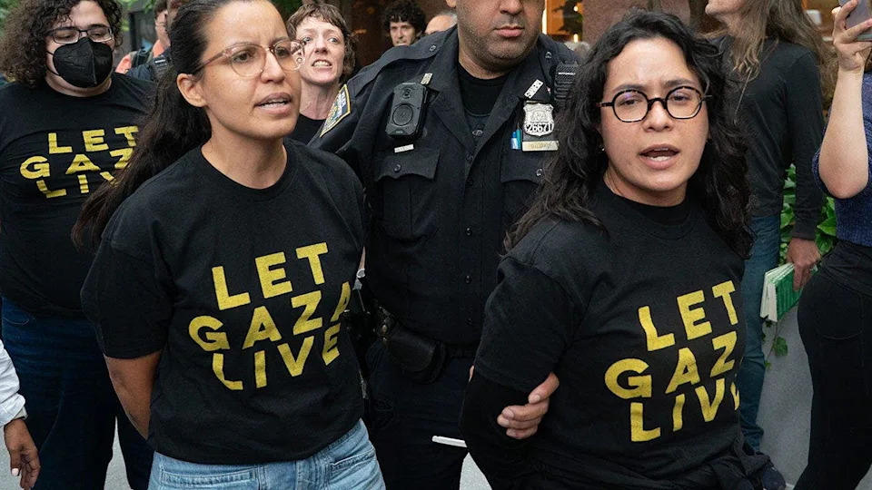 NYPD officers arrest New York City Council member Tiffany Caban and Assembly member Claire Valdez in a building lobby.