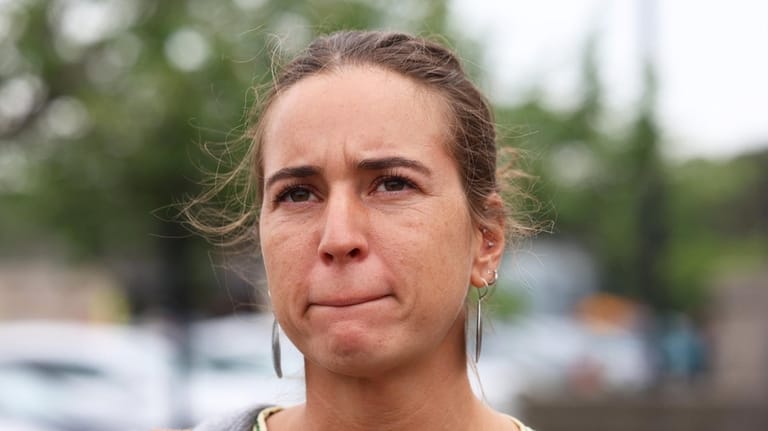 Suffolk resident Melanie Smith becomes emotional last week while she talks outside...