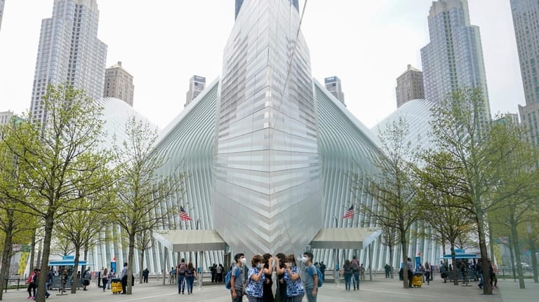 Visitors peek into the museum at the 9/11 Museum and...