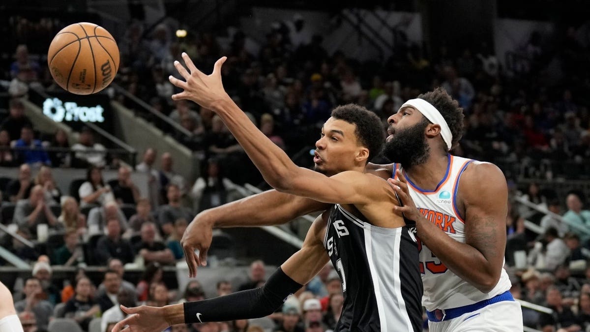 New York Knicks C Mitchell Robinson and San Antonio Spurs big Victor Wembanyama battle for the loose ball at Frost Bank Center in Texas.
