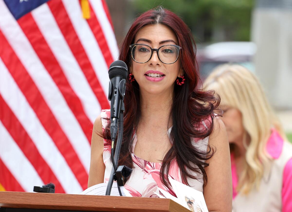 Xiomara Escobar, the president of the Huntington Beach Sand Dollars, talks during Friday's ceremony.