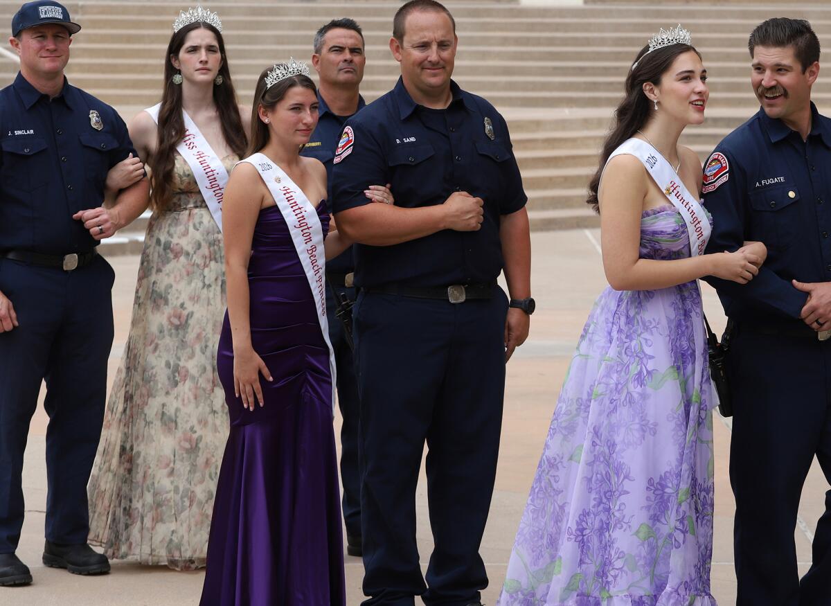 The Miss Huntington Beach royal court are escorted by Huntington Beach firefighters.