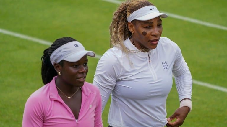 Serena Williams of the United States, left, practices with her...