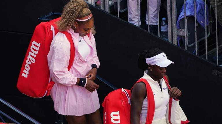 Serena Williams of the United States, left, waits with playing...