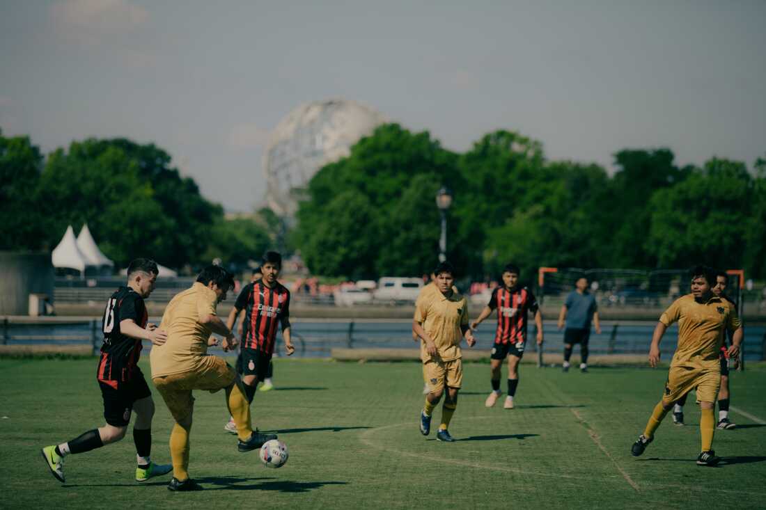 Members of the Fuego FC play against Strong Blood FC on field 5 in Flushing Meadows Corona Park as commotion from echoes off the multiple fields hosting adult recreational league soccer matches in Queens, New York, U.S., on Sunday, June 7, 2026. CREDIT: José A. Alvarado Jr. for NPR, @josealvarado