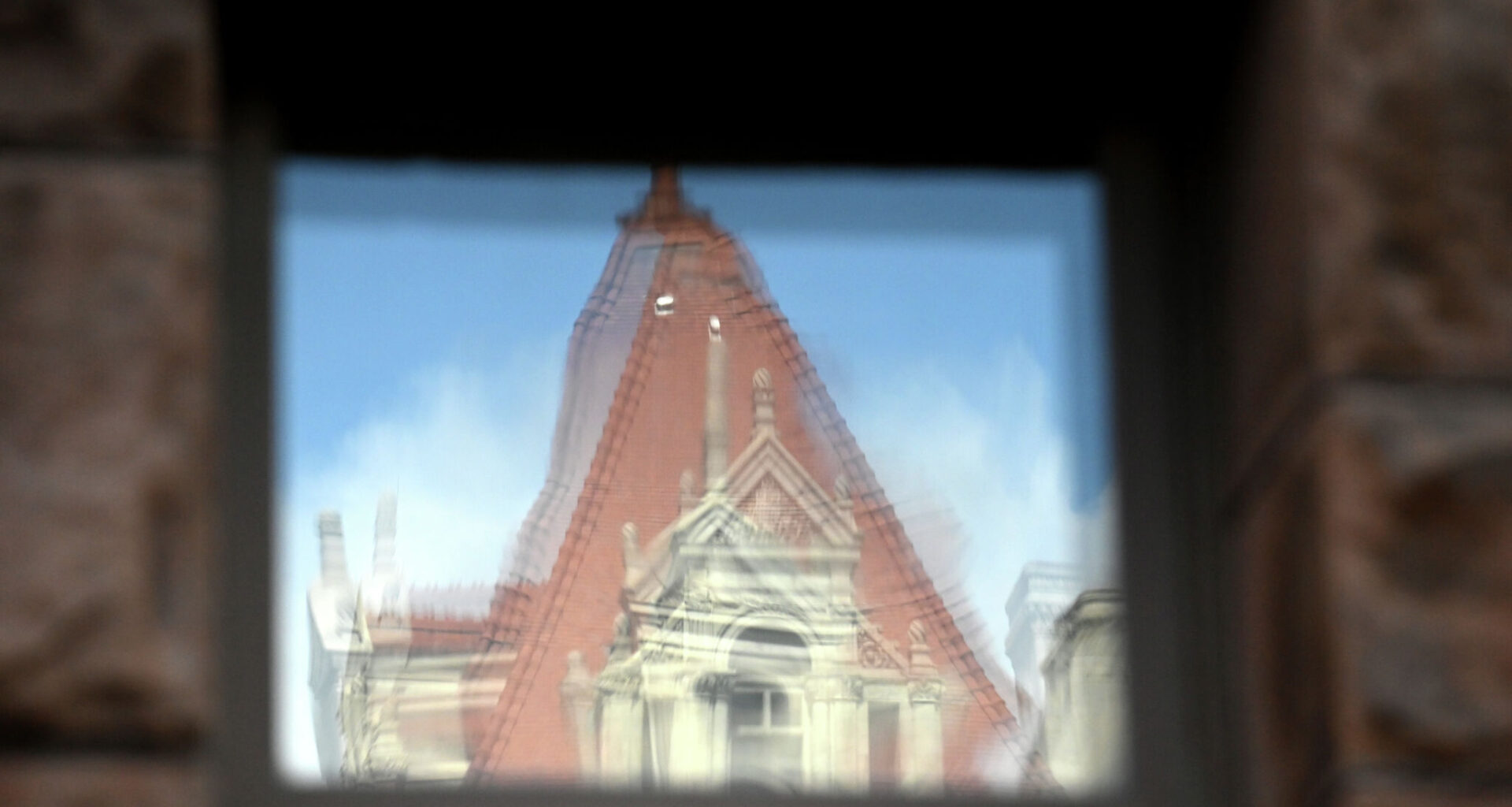 The Capitol is reflected in a window at Albany City Hall on June 1, 2026.