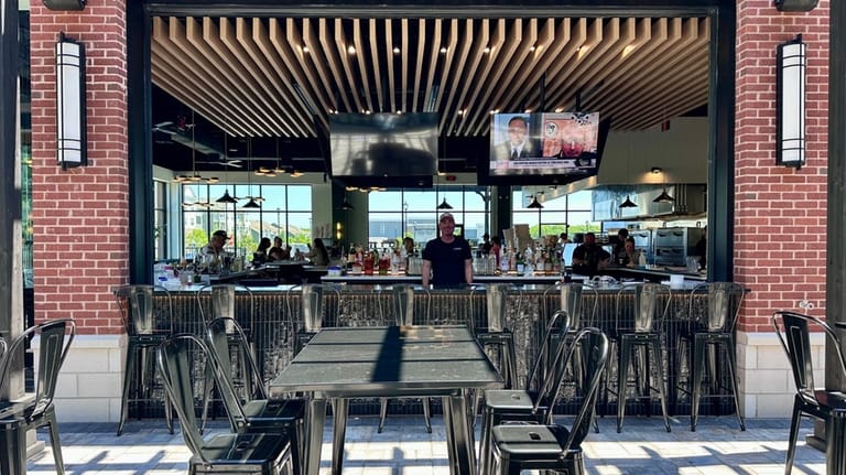 The bar at The Pizzeria in Yaphank opens out onto...
