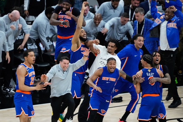 The New York Knicks celebrate after defeating the San Antonio Spurs in Game 5 of the NBA Finals basketball series, Saturday, June 13, 2026, in San Antonio. (AP Photo/Ross D. Franklin)