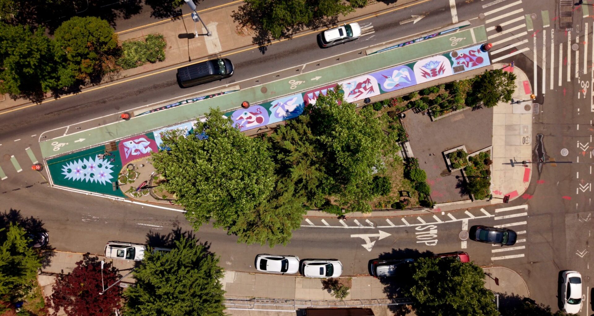 NYC DOT's recently completed art mural at Father Studzinski Square, delivered as part of the redesign of McGuinness Boulevard, which brought expanded painted pedestrian space and a barrier-protected bike lane along the Brooklyn street. Photo credit: Ben Wolf