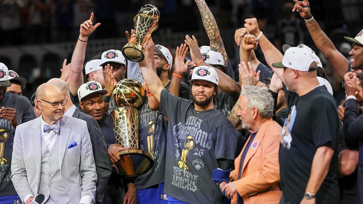 New York Knicks guard Jalen Brunson celebrating with teammates on basketball court.