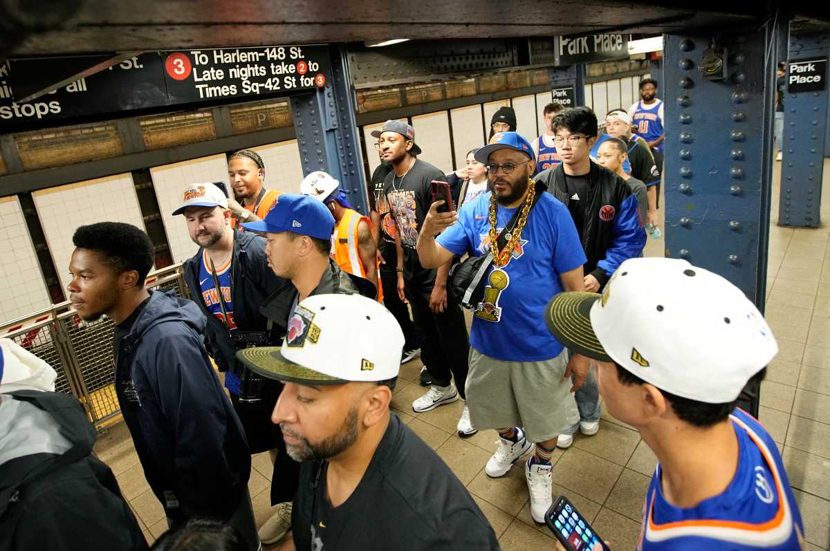 Knicks fans wait on subway platform while heading to ticker-tape parade