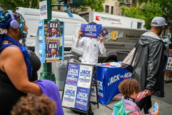 A person campaigns for Democratic Congressional Candidate Jack Schlossberg during New York's primary election on Tuesday, June 23, 2026, in New York. (AP Photo/Ryan Murphy)