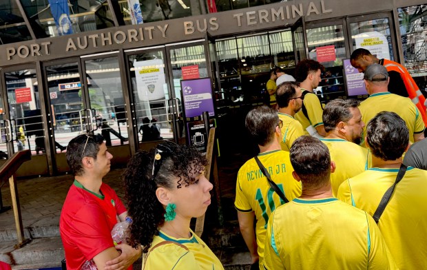 Soccer fans line up at the Port Authority Bus Terminal in Manhattan to catch official shuttle buses to the World Cup game in New Jersey on Saturday afternoon.