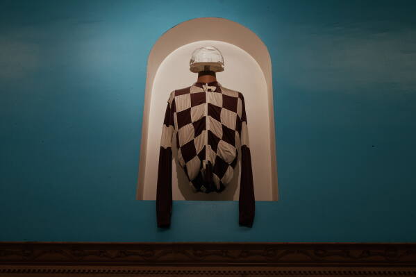 A jockey's silks are on exhibit inside Aqueduct Racetrack in the Queens borough of New York, Saturday, June 27, 2026. (AP Photo/Andres Kudacki)