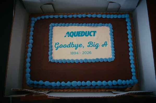 A cake marking the closing of Aqueduct Racetrack is displayed on closing day in the Queens borough of New York, Sunday, June 28, 2026. (AP Photo/Andres Kudacki)
