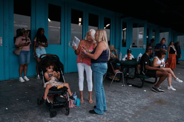 People gather outside the grandstand at Aqueduct Racetrack in the Queens borough of New York, Saturday, June 27, 2026. (AP Photo/Andres Kudacki)