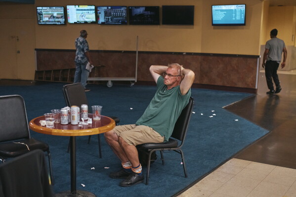 A man watches the races inside Aqueduct Racetrack in the Queens borough of New York, Sunday, June 28, 2026. (AP Photo/Andres Kudacki)