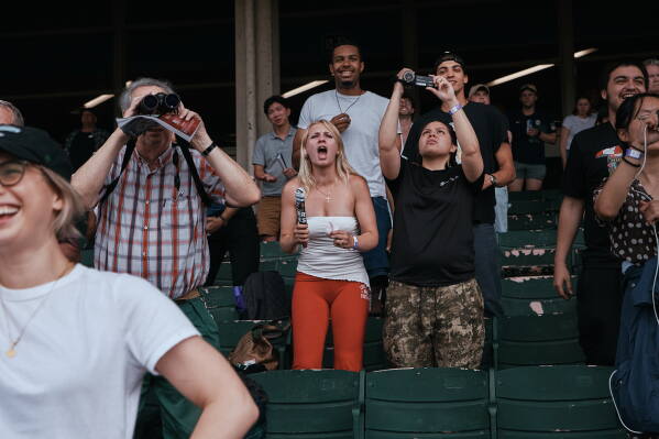 People watch a race at Aqueduct Racetrack in the Queens borough of New York, Saturday, June 27, 2026. (AP Photo/Andres Kudacki)