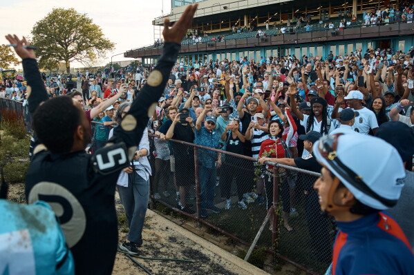 Jockey Kendrick Carmouche greets the crowd following the final race on the closing day at Aqueduct Racetrack in the Queens borough of New York, Sunday, June 28, 2026. (AP Photo/Andres Kudacki)